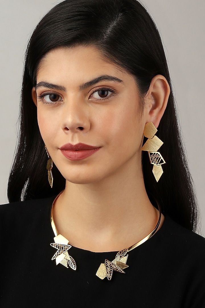 Yellow Gold Finish Edged Stud Earrings by Itrana By Sonal Gupta