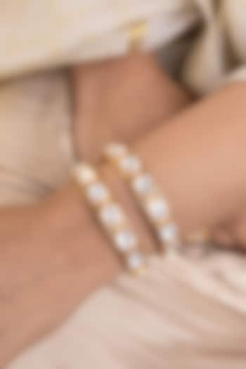 Gold Finish Kundan Polki & Pearl Bangles (Set Of 2) by Joules By Radhika at Pernia's Pop Up Shop