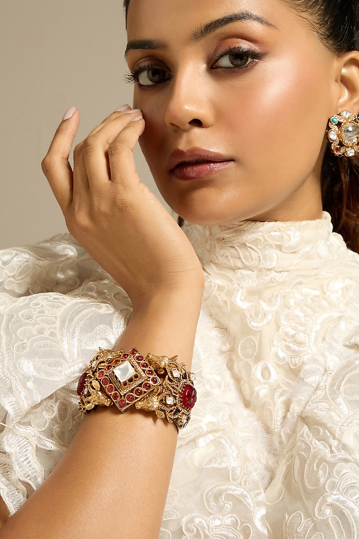 Gold Finish Motifs & Red Stone Handcrafted Bracelet by Joules By Radhika at Pernia's Pop Up Shop