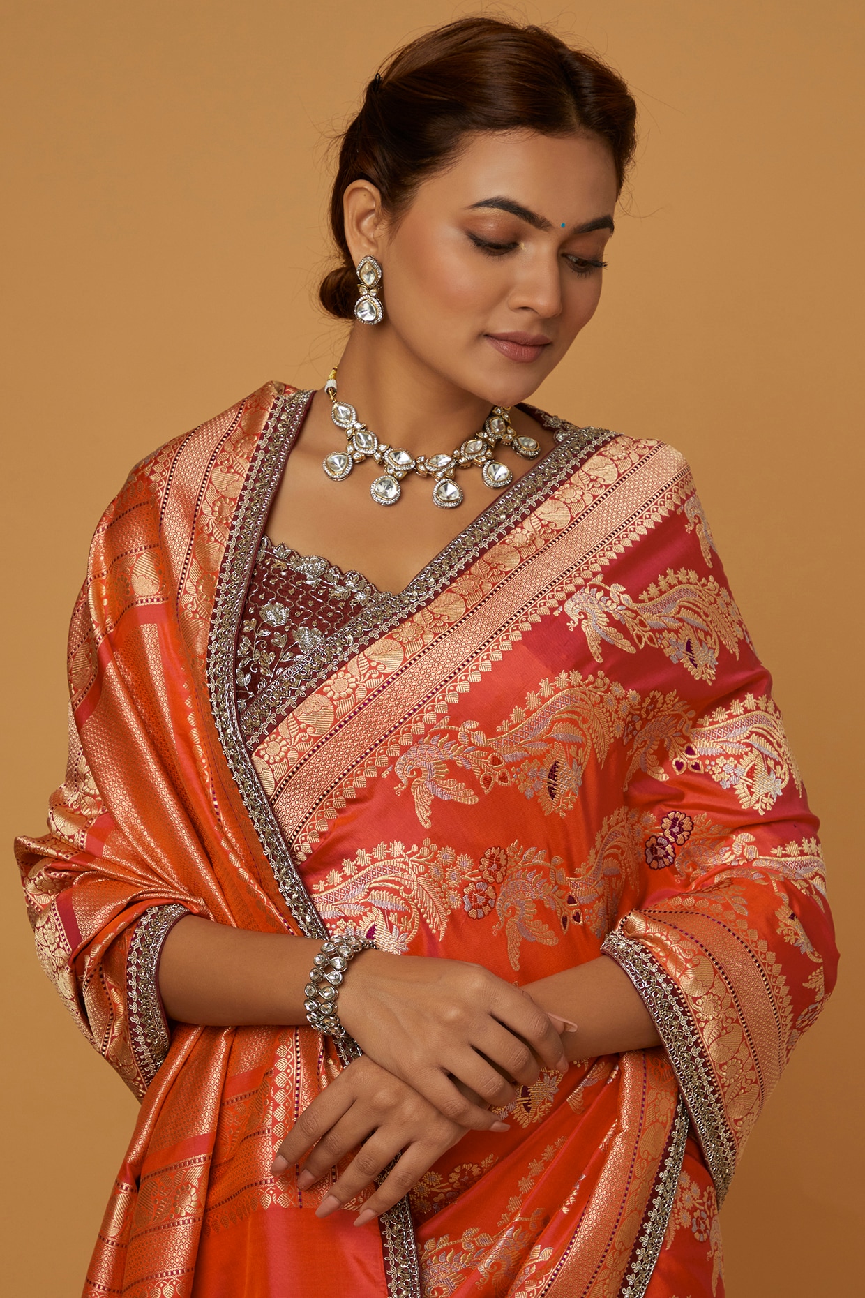 In a gorgeous orange color saree, elbow length sleeve blouse design,  necklace, long chain and jewelry | Saree hairstyles, Saree wedding, Saree  draping styles