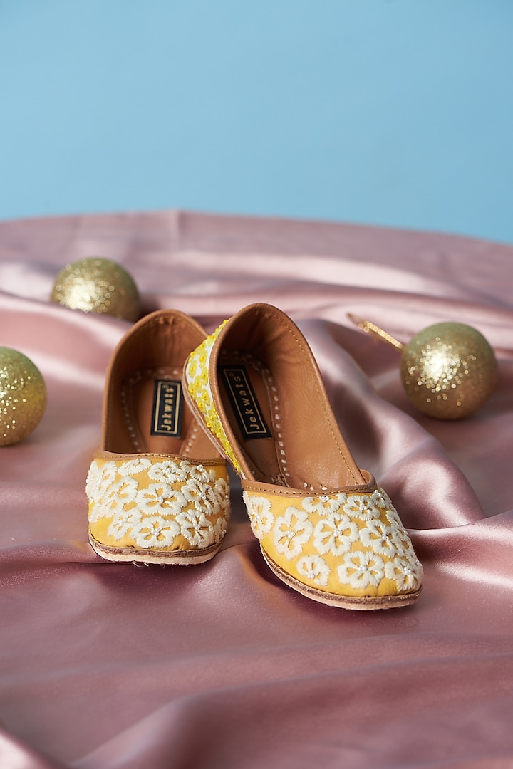 Yellow & Ivory Cotton Silk Thread Embellished Juttis For Girls by Jekwats at Pernia's Pop Up Shop