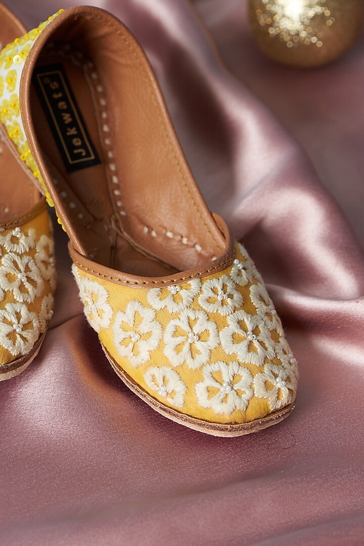 Yellow & Ivory Cotton Silk Thread Embellished Juttis For Girls by Jekwats at Pernia's Pop Up Shop