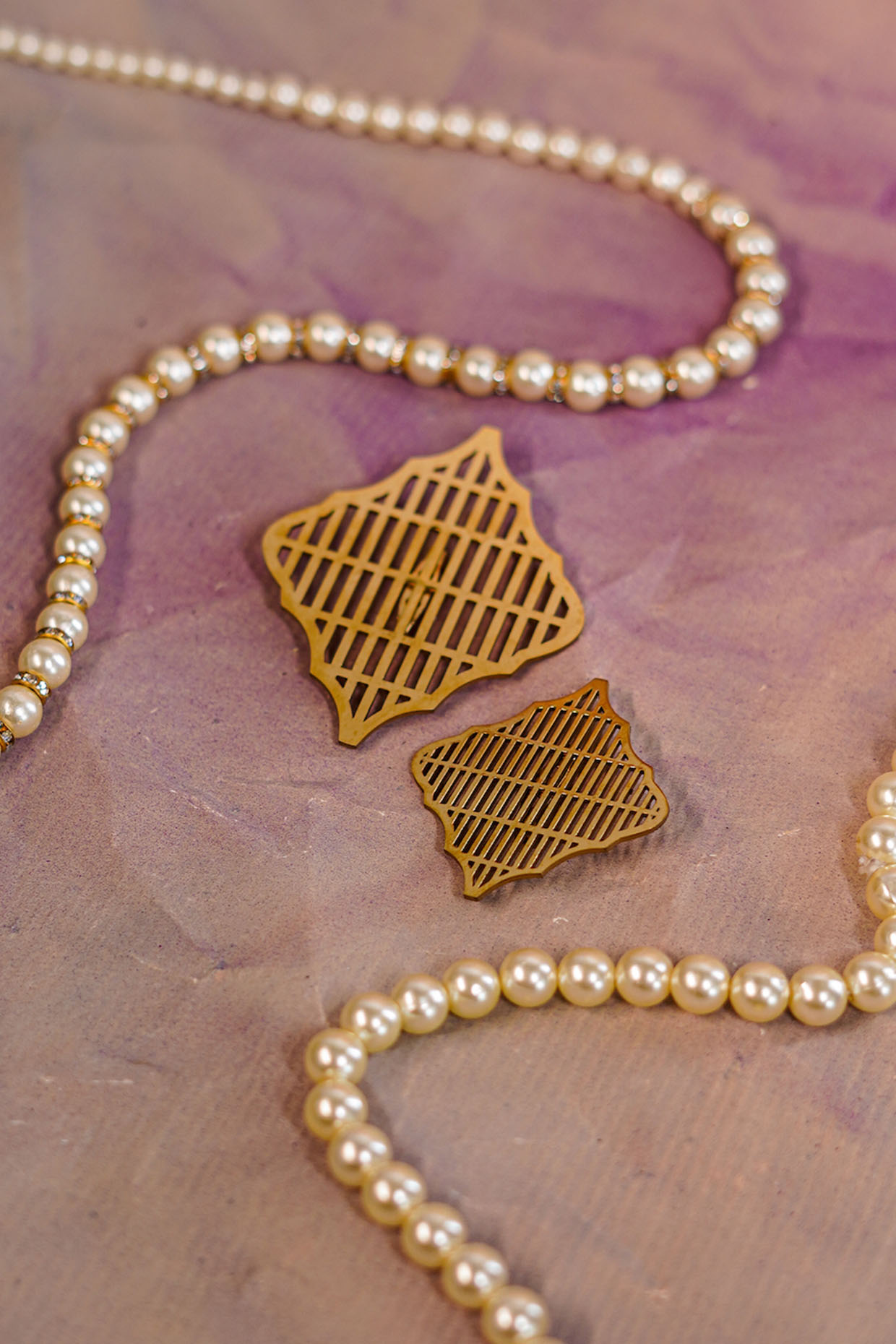 Gold Metal Handmade Kalgis (Set of 2) by Jatin Malik at Pernia's Pop Up Shop