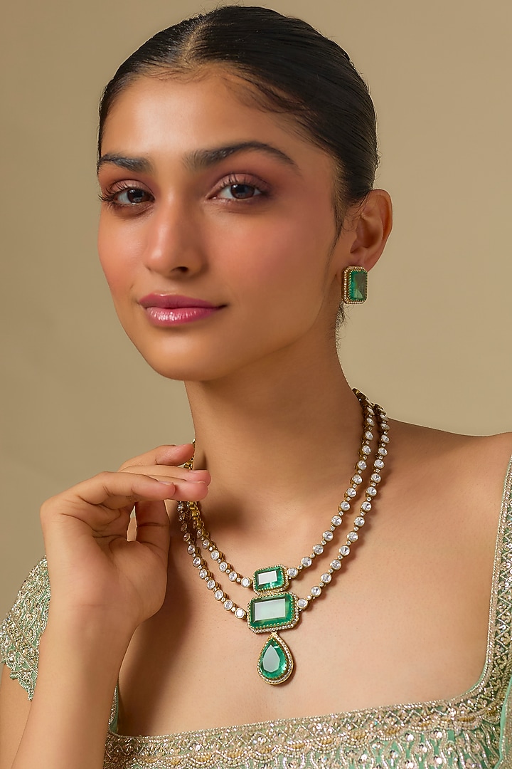 Gold Finish Kundan Polki & Emerald Stone Layered Necklace Set In Sterling Silver by Kiara Luxe at Pernia's Pop Up Shop