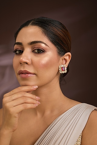 Gold Finish Kundan Polki & Ruby Stone Stud Earrings In Sterling Silver by Kiara Luxe