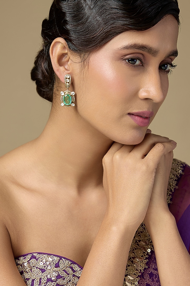 Gold Finish Kundan Polki & Oval-Cut Emerald Stone Dangler Earrings In Sterling Silver by Kiara Luxe at Pernia's Pop Up Shop