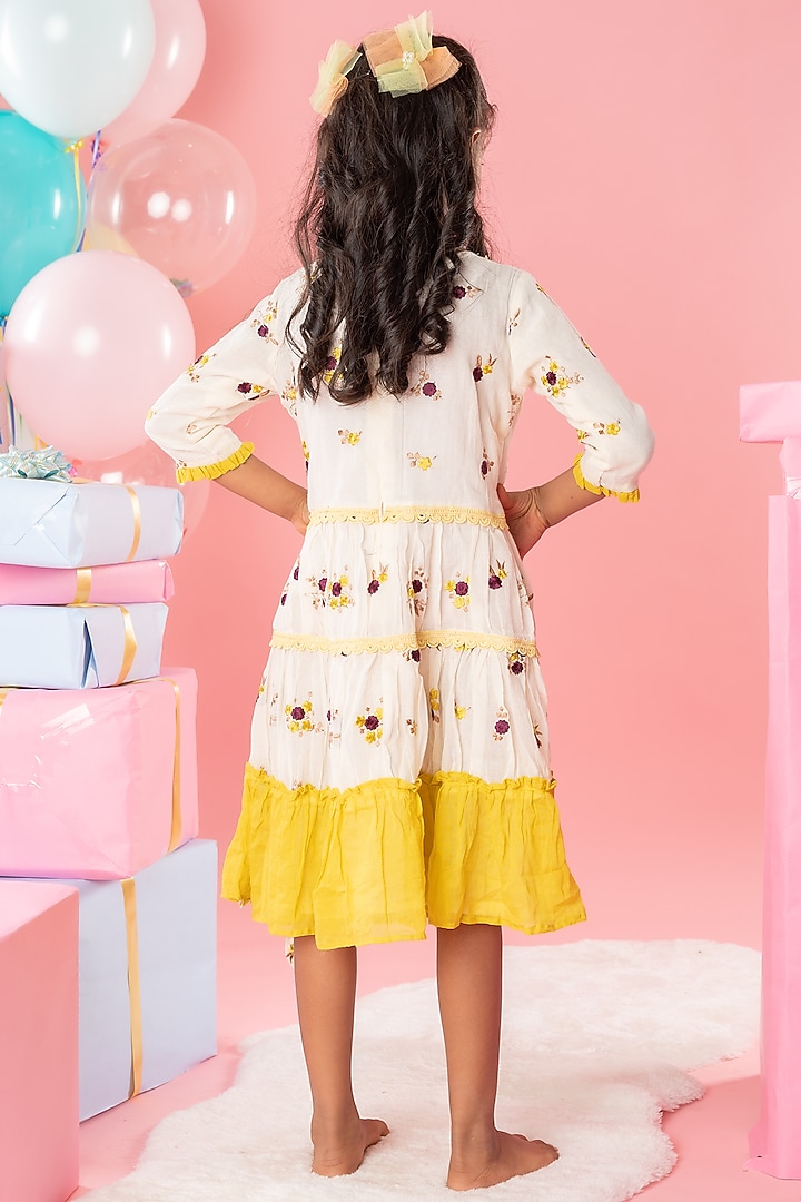 Off-White & Yellow Pure Cotton Tassels Embroidered Ruffled Dress For Girls by Kirti Agarwal Pret n Couture at Pernia's Pop Up Shop