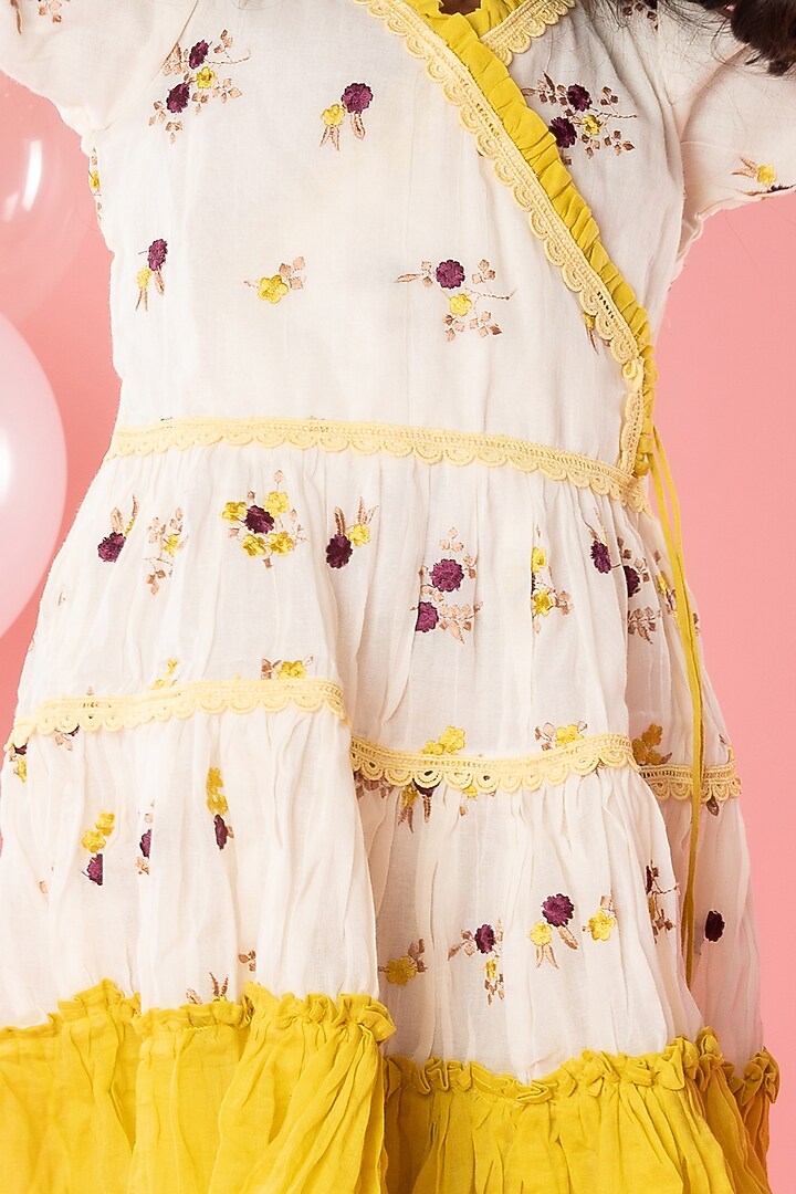 Off-White & Yellow Pure Cotton Tassels Embroidered Ruffled Dress For Girls by Kirti Agarwal Pret n Couture at Pernia's Pop Up Shop