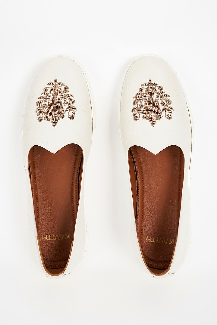 White Handcrafted Juttis With Gold Embroidery by Kavith