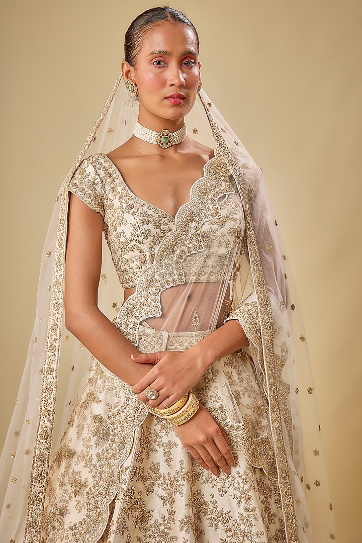 Ivory Raw Silk Hand & Machine Embroidered Bridal Lehenga Set by Kalighata at Pernia's Pop Up Shop