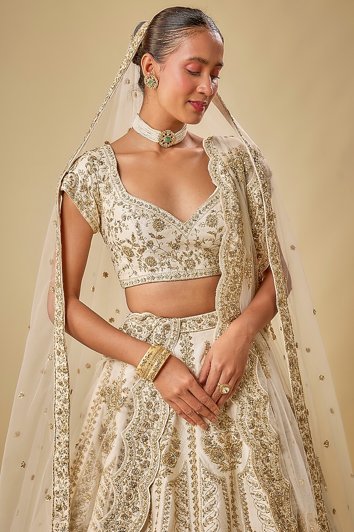 Ivory Raw Silk Hand & Machine Embroidered Bridal Lehenga Set by Kalighata at Pernia's Pop Up Shop