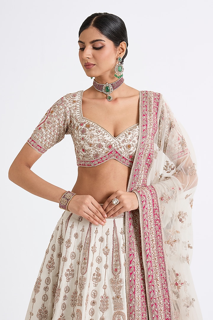 Ivory Raw Silk Zari Hand & Machine Embroidered Bridal Lehenga Set by Kalighata at Pernia's Pop Up Shop