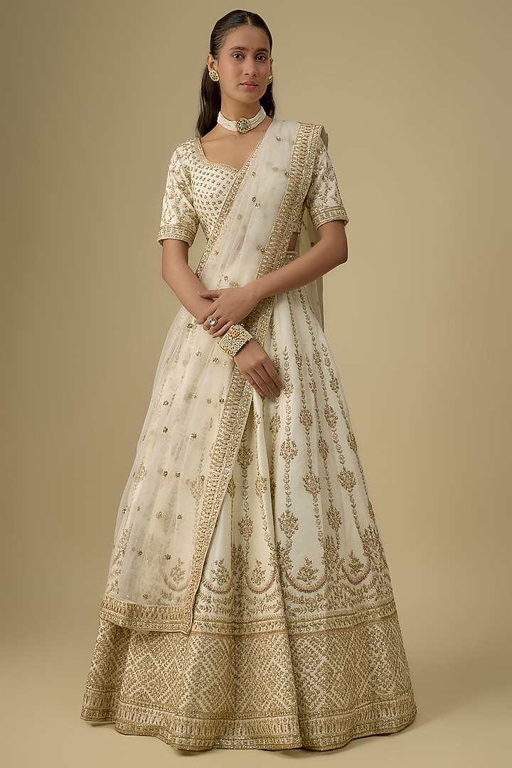 Ivory Raw Silk Hand & Machine Embroidered Bridal Lehenga Set by Kalighata at Pernia's Pop Up Shop