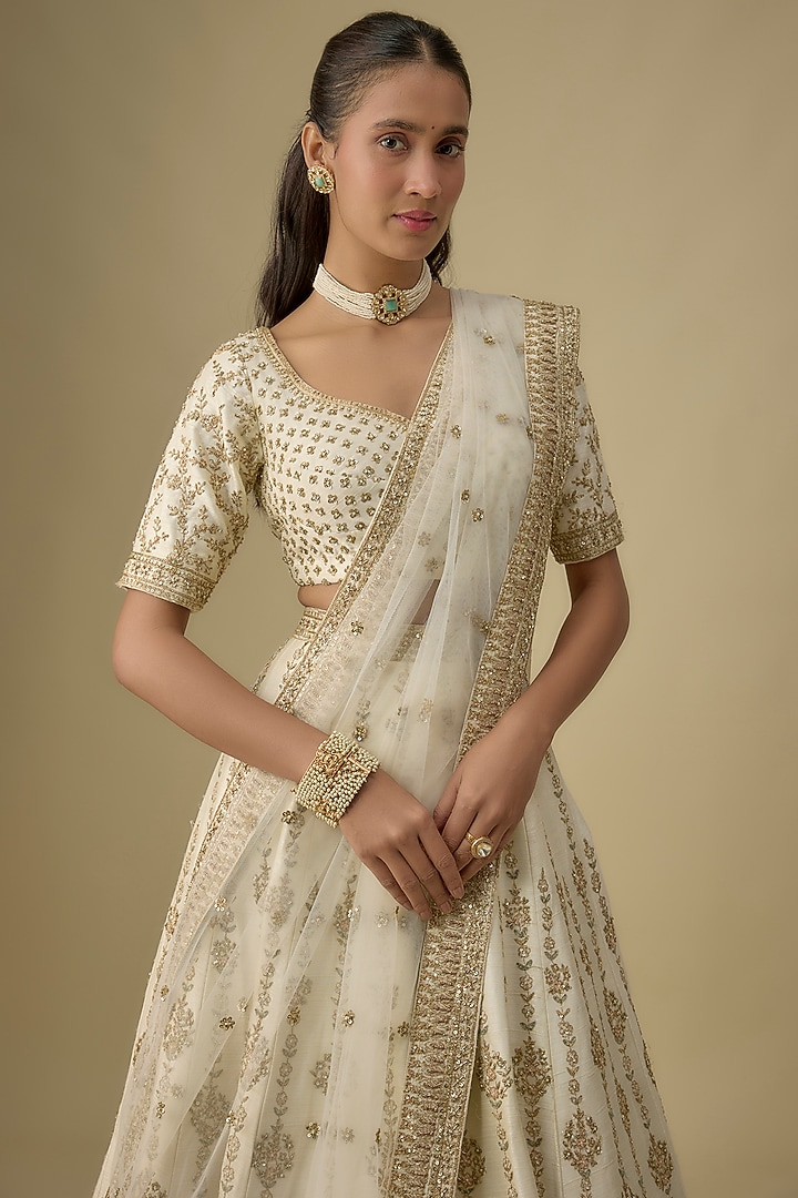Ivory Raw Silk Hand & Machine Embroidered Bridal Lehenga Set by Kalighata at Pernia's Pop Up Shop