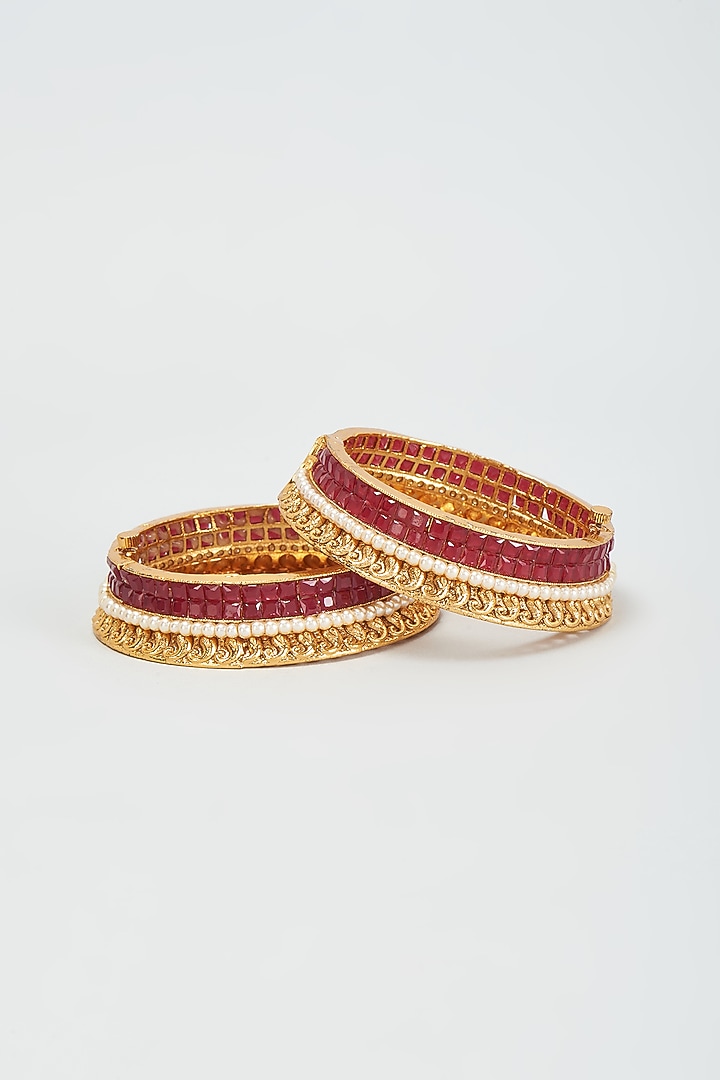 Gold Finish Red Stone & Moti Bangles (Set Of 2) by Khushi Jewels at Pernia's Pop Up Shop