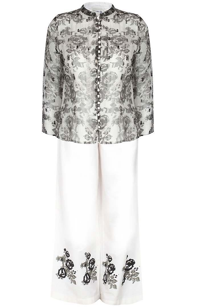 White and black floral print jacket with off white pants by Krishna Mehta