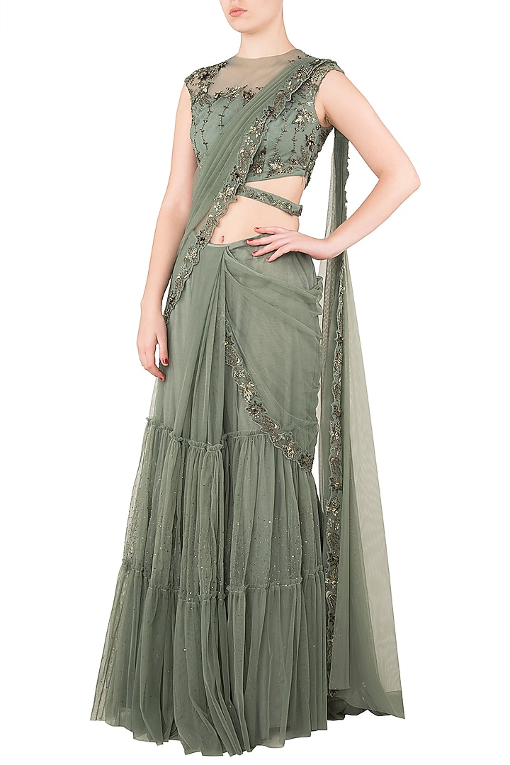 Moss green tiered sari with net cut out blouse available only at Pernia's Pop Up Shop.