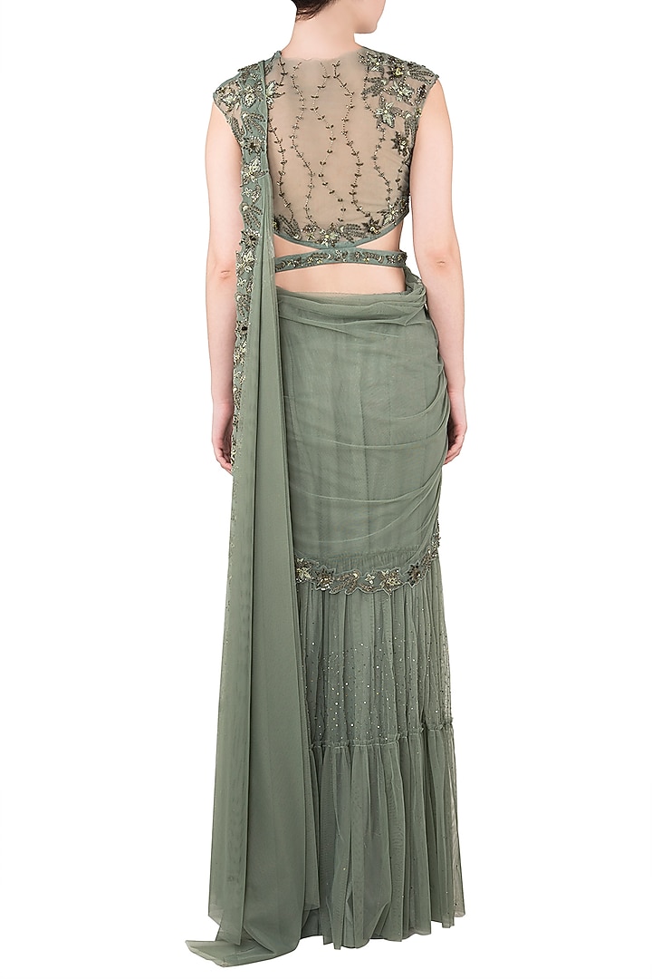 Moss green tiered sari with net cut out blouse available only at Pernia's Pop Up Shop.