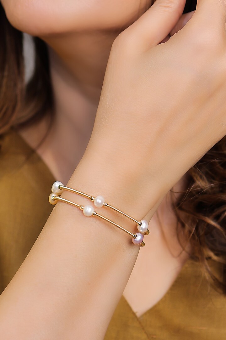 Gold Finish Pearl Openable Bangles (Set Of 2) by KRAFTSMITHS at Pernia's Pop Up Shop