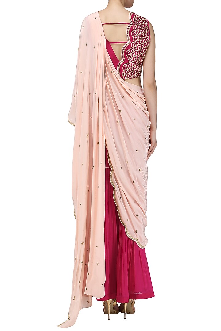 Fuschia pink embroidered blouse with attached drape and gharara pants set available only at Pernia's Pop Up Shop.