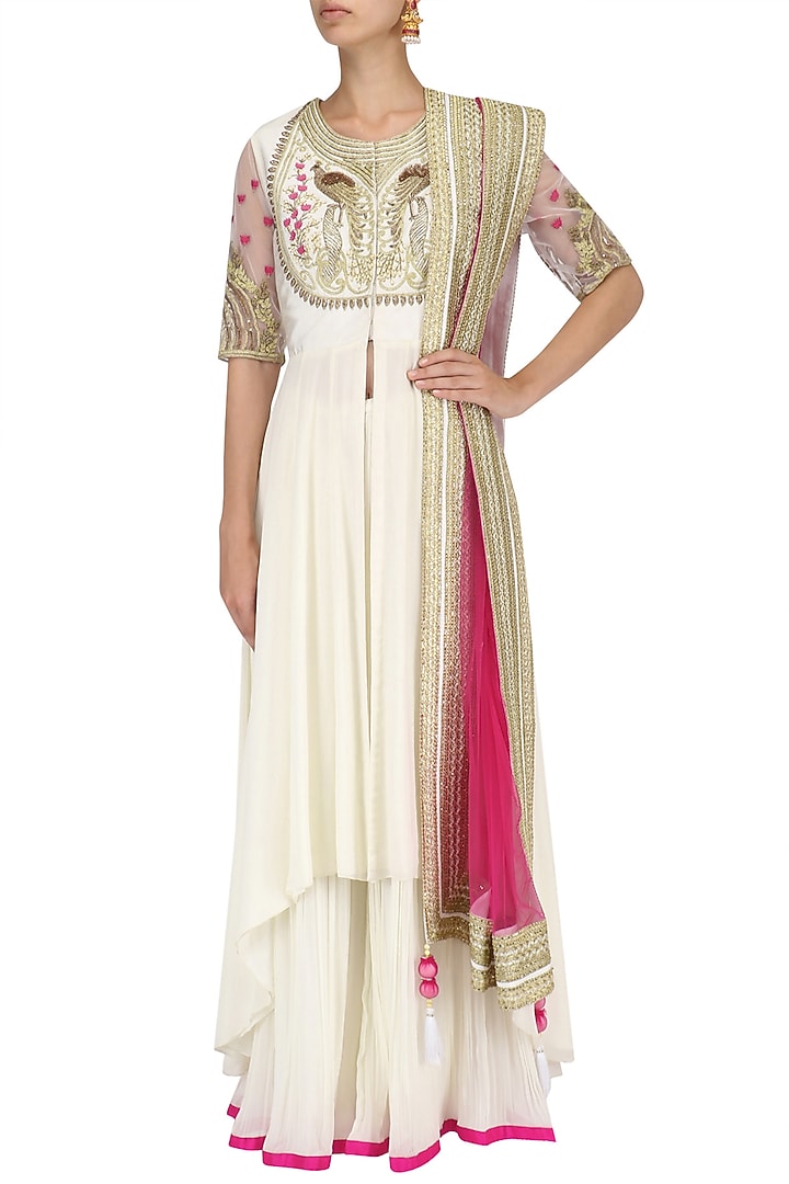 Ivory peacock motif embroidered asymmetrical kurta and sharara set available only at Pernia's Pop Up Shop.