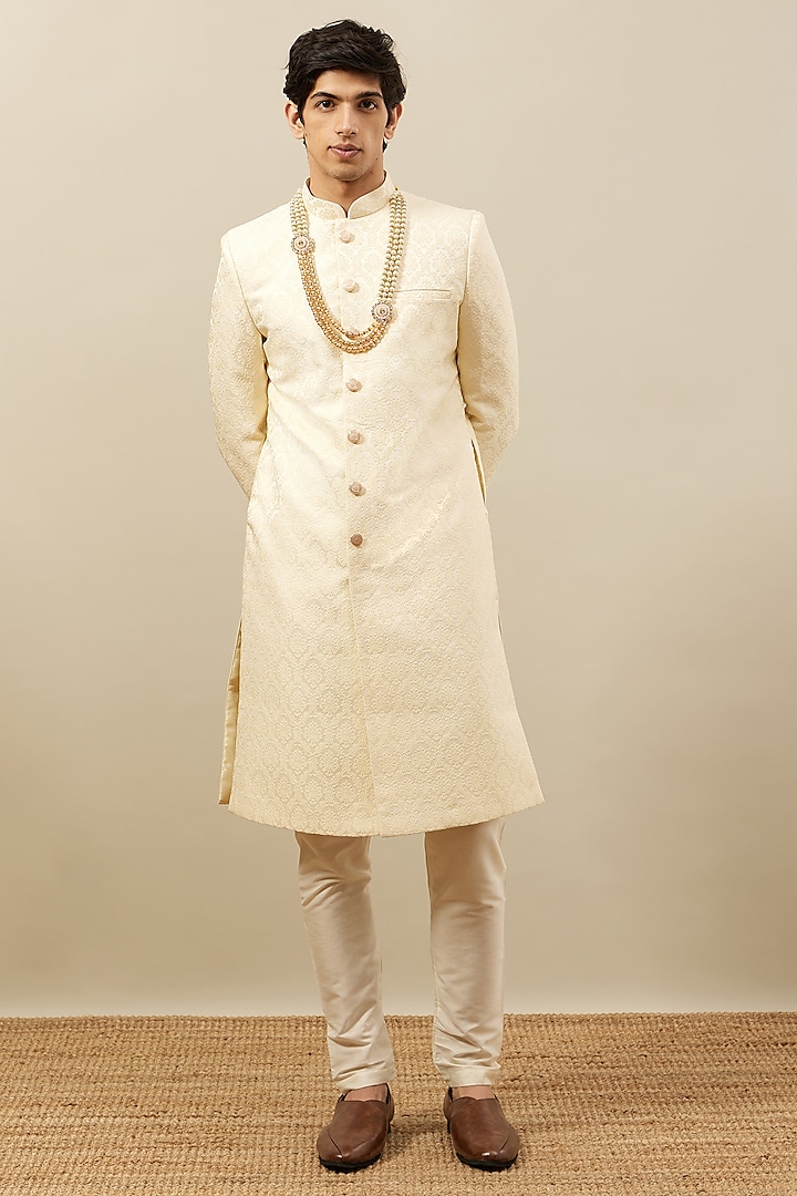 Cream Brocade Self-Textured Sherwani Set by Manyavar