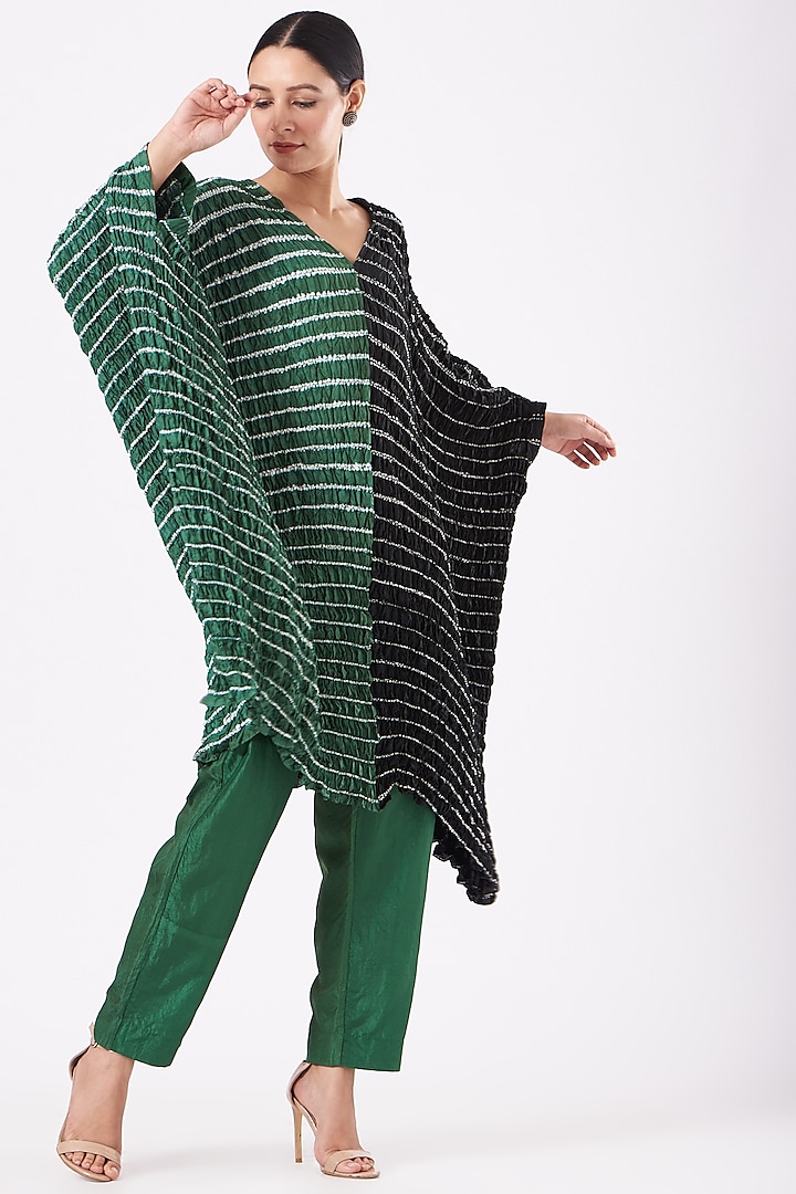 Featuring a bottle green and black handwoven kaftan in silk base with shibori pattern and hand dyed print. This contains only one piece.

FIT: Cut for relaxed fit.
COMPOSITION: Silk.
CARE: Dry clean only. by Medium