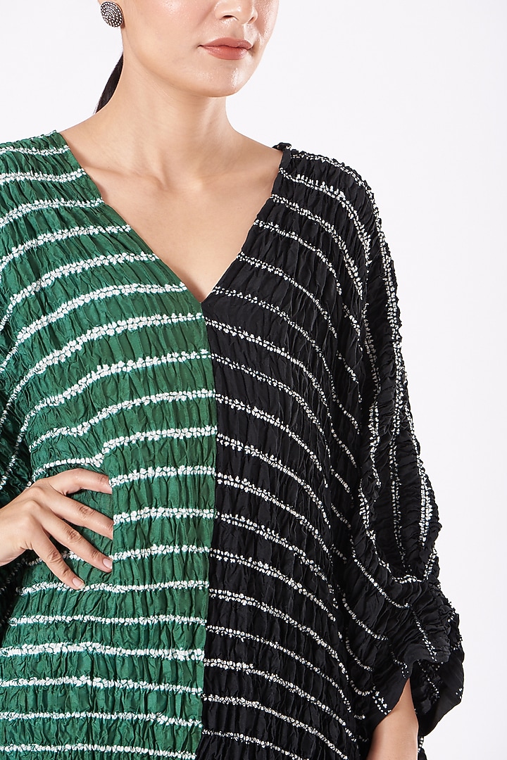 Featuring a bottle green and black handwoven kaftan in silk base with shibori pattern and hand dyed print. This contains only one piece.
FIT: Cut for relaxed fit.
COMPOSITION: Silk.
CARE: Dry clean only. by Medium at Pernia's Pop Up Shop