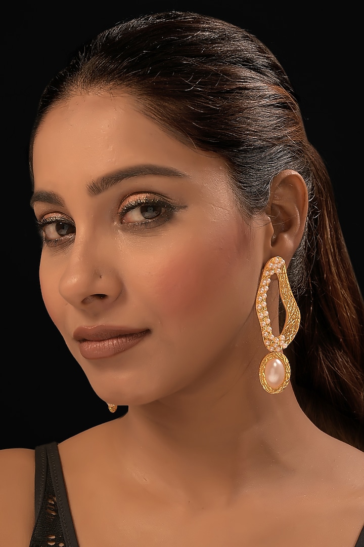 Gold Finish Pearl Dangler Earrings by MEDOSO JEWELLERY at Pernia's Pop Up Shop