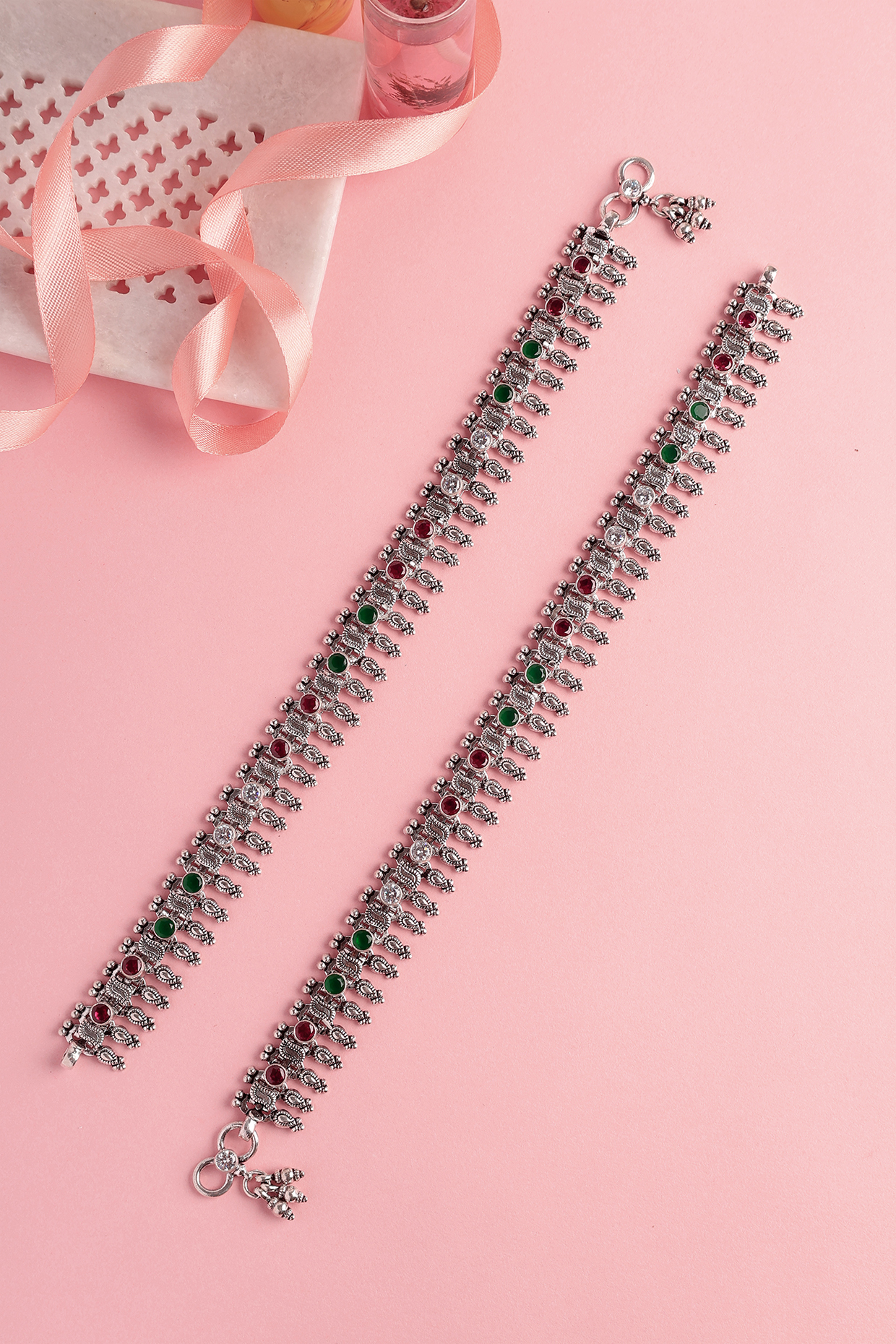 White Finish Ruby & Green Stone Temple Spoke Anklets In Sterling Silver (Set Of 2) by Mero at Pernia's Pop Up Shop