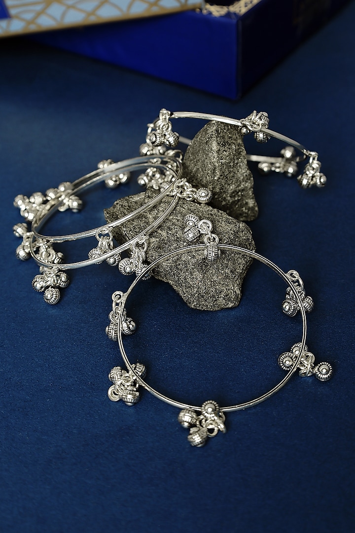 White Finish Ghungroo Temple Bangles In Sterling Silver (Set Of 4) by Mero at Pernia's Pop Up Shop
