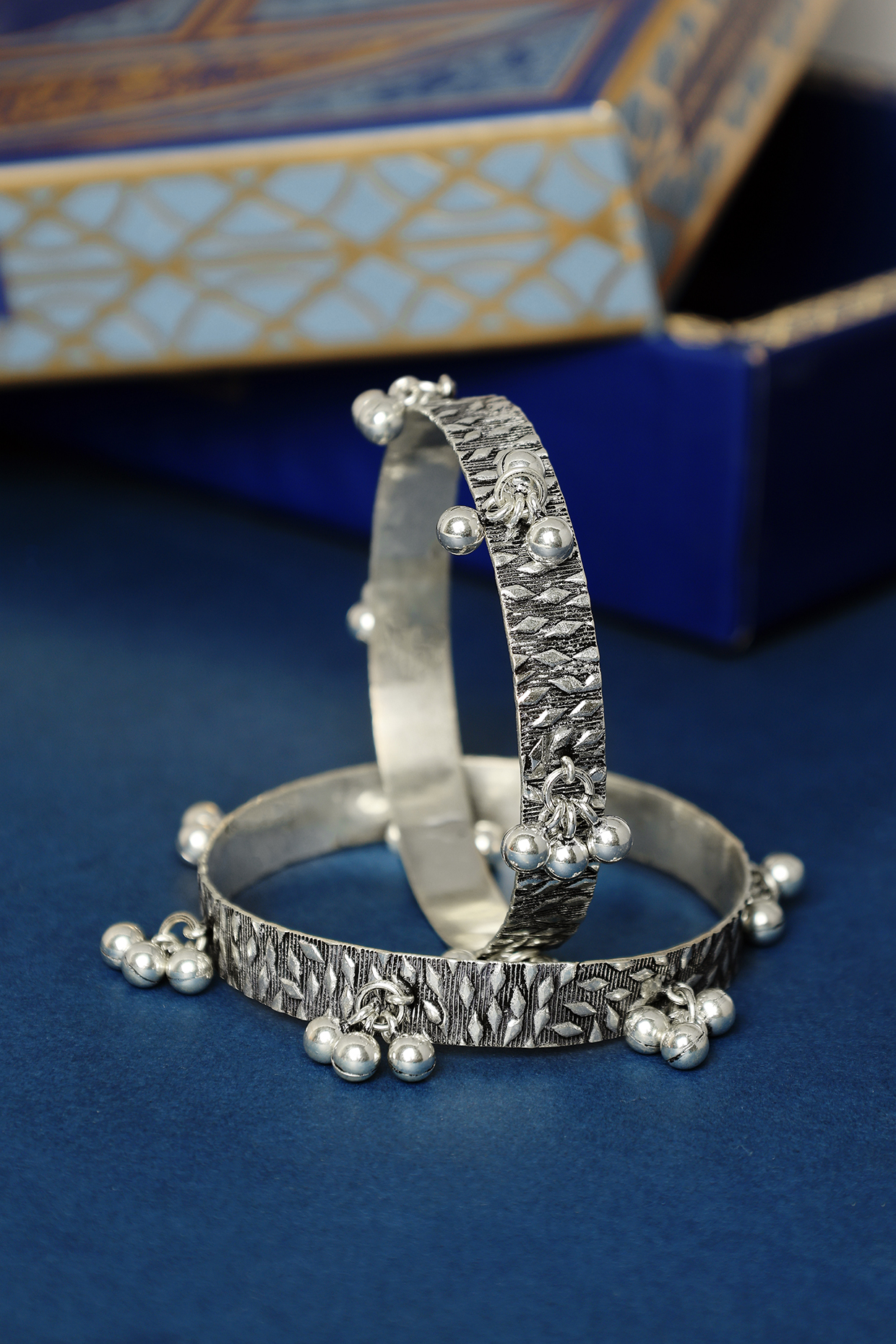 White Finish Temple Ghungroo Bangles In Sterling Silver (Set Of 2) by Mero at Pernia's Pop Up Shop