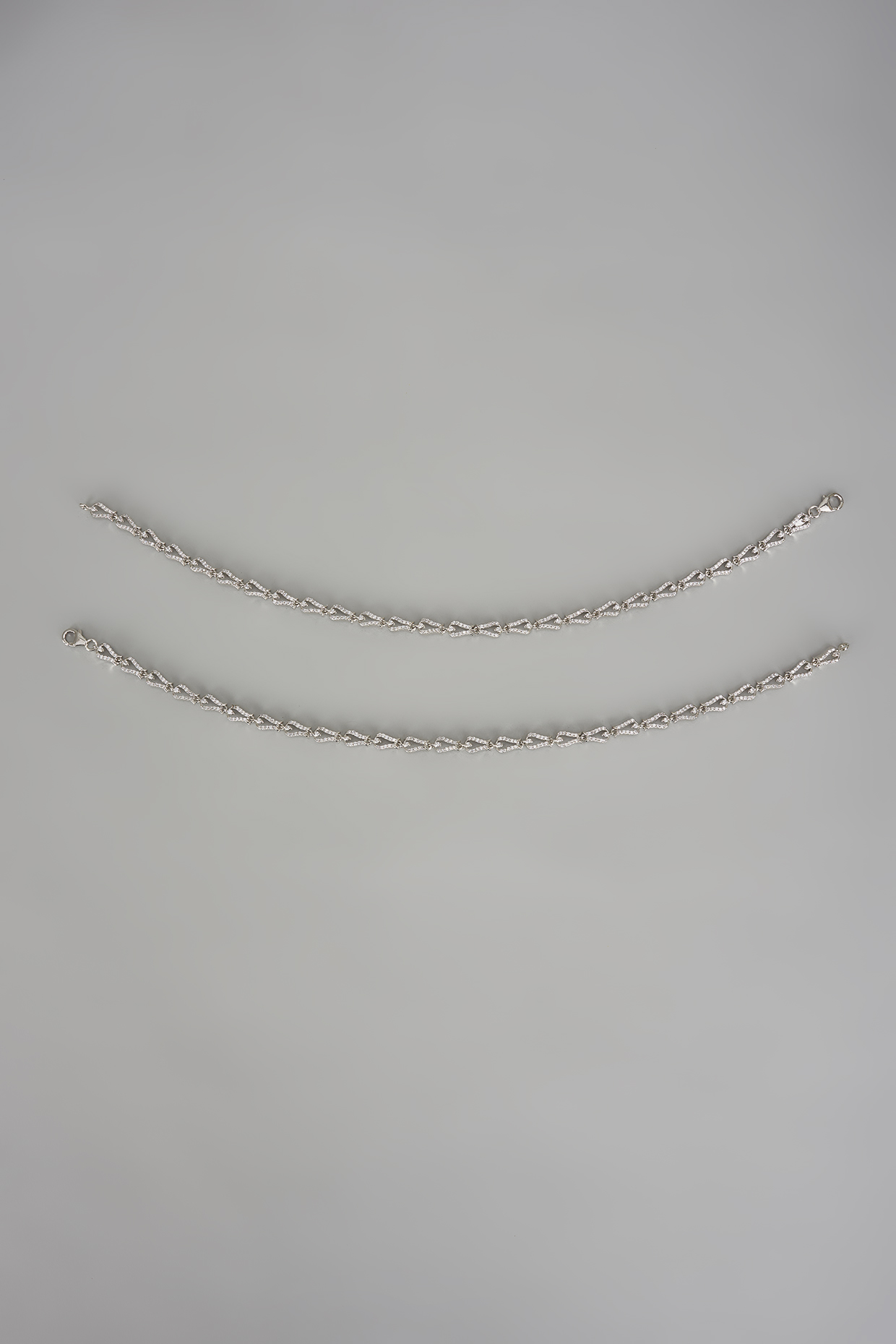 White Finish Cubic Zircon Anklets In Sterling Silver (Set Of 2) by Mero at Pernia's Pop Up Shop