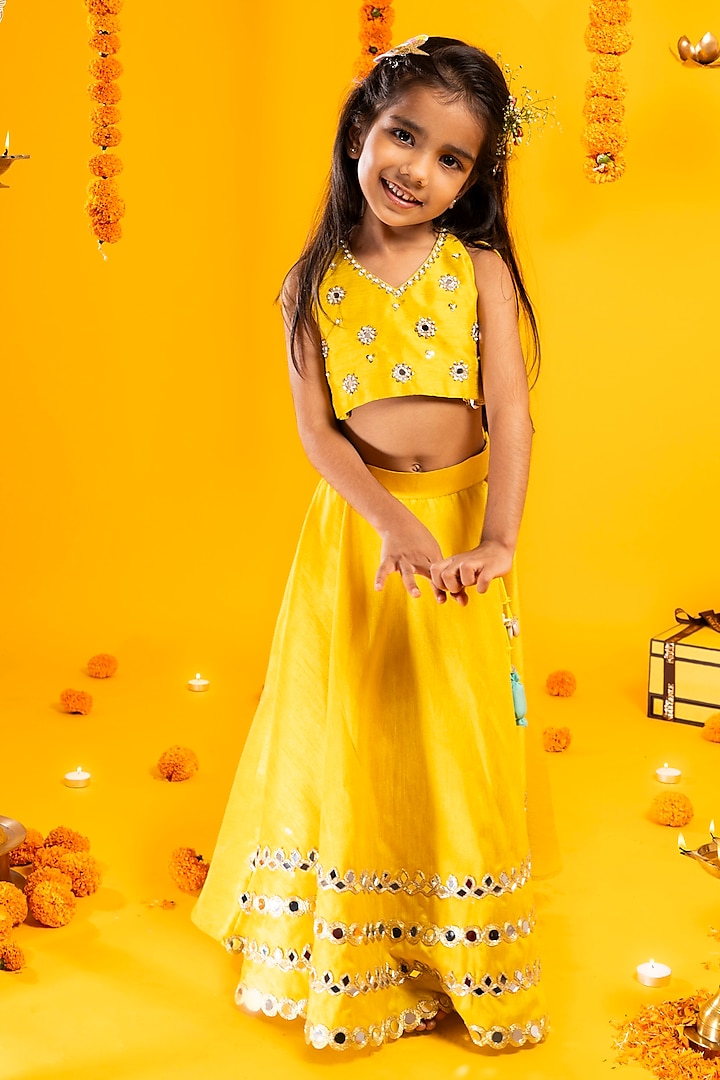 Mustard Yellow Cotton Silk Mirror Hand Embroidered Lehenga Set For Girls by Metaphor Kids at Pernia's Pop Up Shop