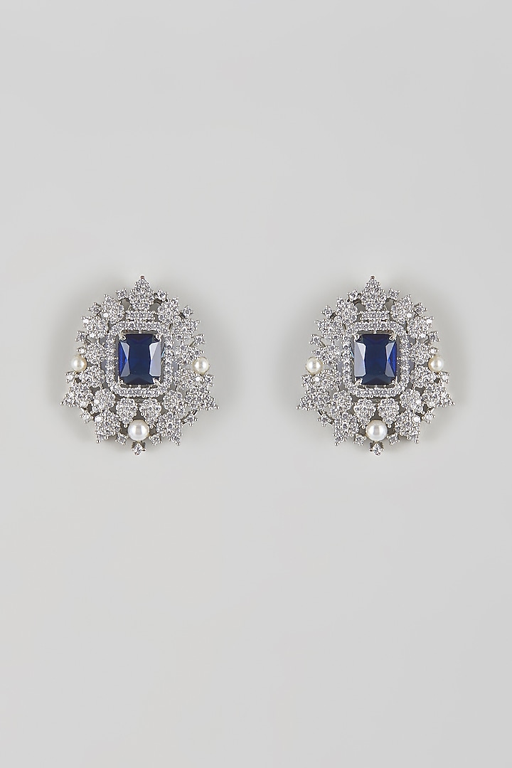 White Gold Finish Zircon & Sapphire Blue Stone Stud Earrings by Moh-Maya by Disha Khatri at Pernia's Pop Up Shop