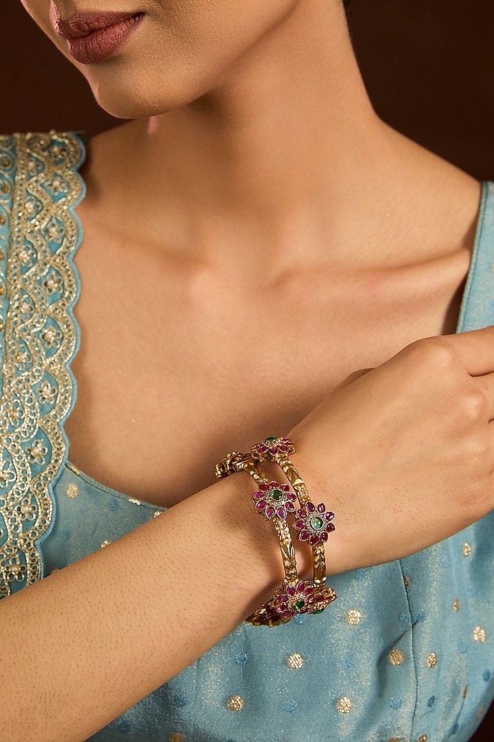 Gold Finish Emerald & Ruby Stone Floral Bangles (Set Of 2) by Moh-Maya by Disha Khatri at Pernia's Pop Up Shop
