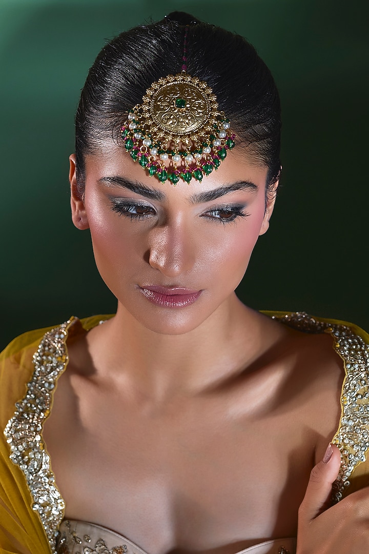 Gold Finish Emerald Stone Maang Tikka by Moh-Maya by Disha Khatri at Pernia's Pop Up Shop