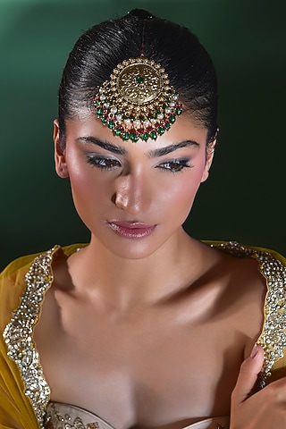 Gold Finish Emerald Stone Maang Tikka by Moh-Maya by Disha Khatri