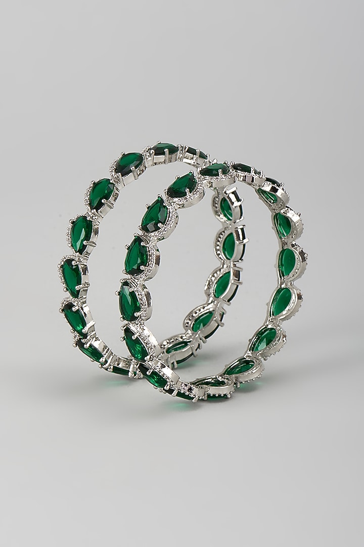 Silver Finish Zircon & Emerald Stone Bangles (Set Of 2) by Moh-Maya by Disha Khatri at Pernia's Pop Up Shop
