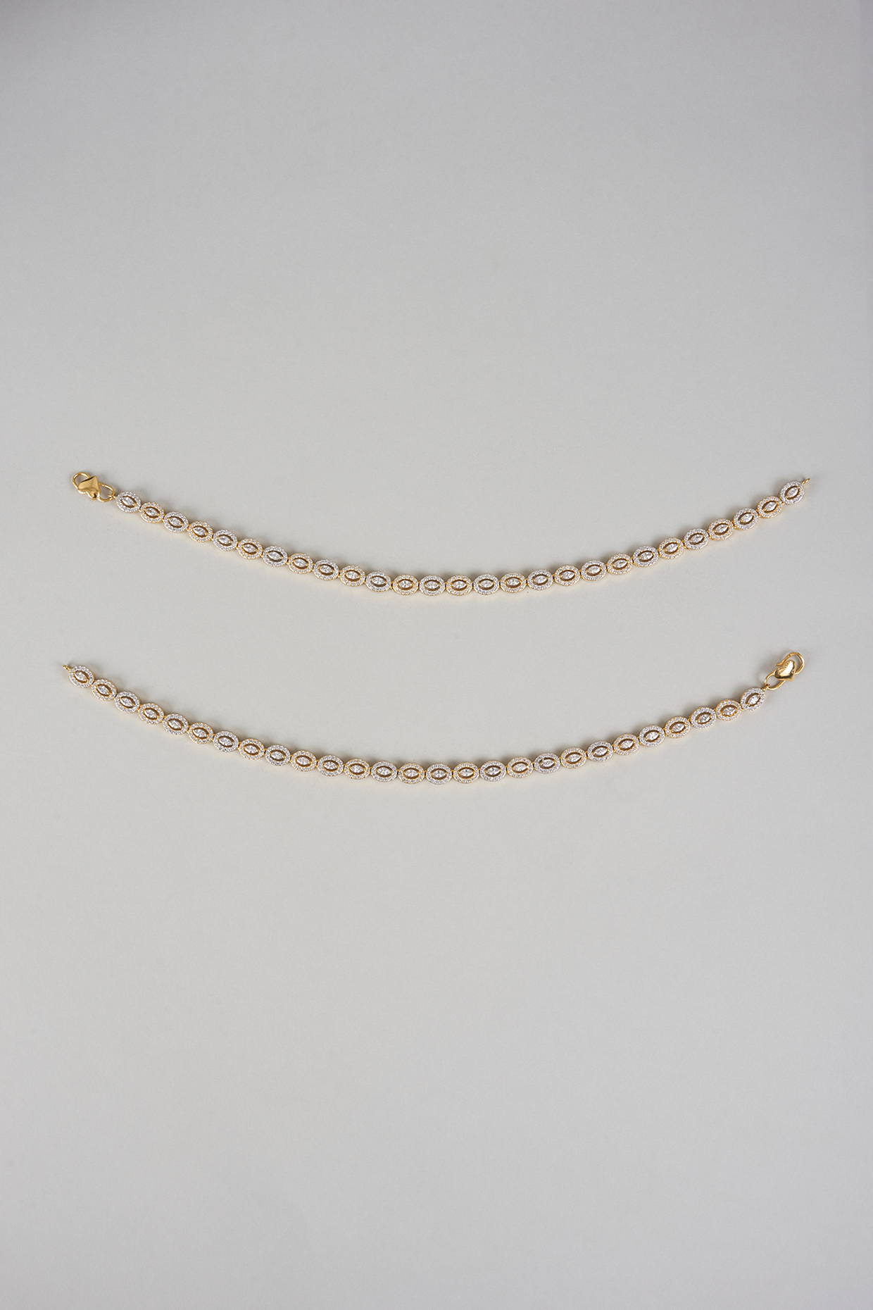 Gold Finish Zircon Anklets (Set Of 2) by Moh-Maya by Disha Khatri at Pernia's Pop Up Shop