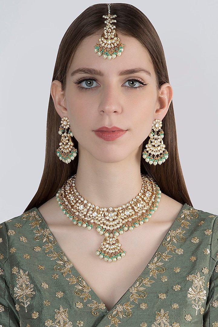 Gold Finish Green Stones Necklace Set With Maang Tikka by Moh-Maya by Disha Khatri
