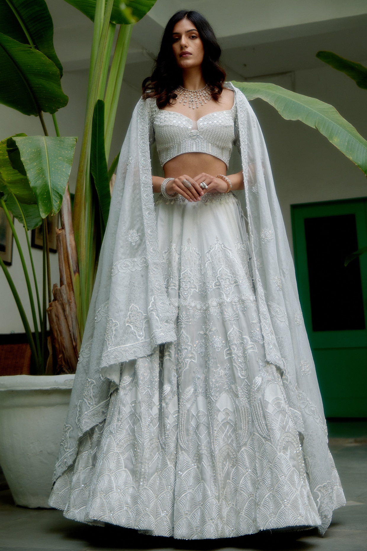 BEIGE GOLD CLASSIC LEHENGA SET WITH ALL OVER SILVER ZARI PATTERNED  EMBROIDERY PAIRED WITH A MATCHING EMBROIDERED DUPATTA AND SILVER AND HAND  EMBROIDERED FLORAL EMBELLISHMENTS. - Seasons India