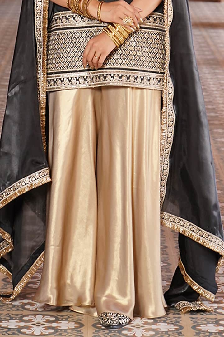 Gold Satin Party Wear Sharara Set by Monk & Mei at Pernia's Pop Up Shop