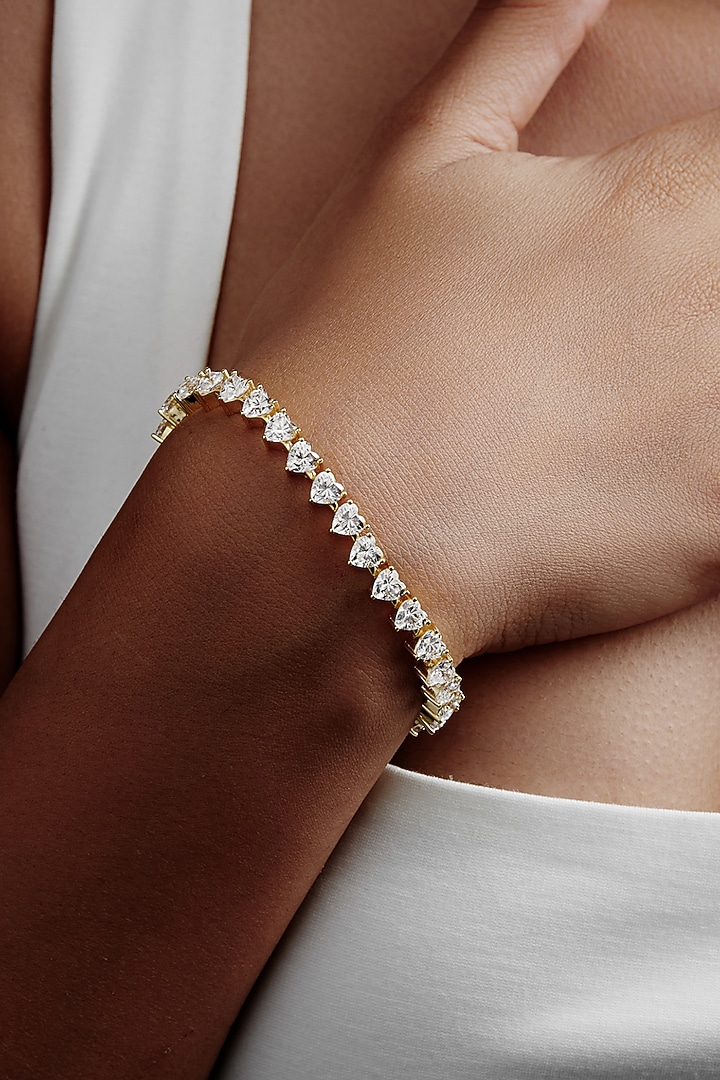 Gold Finish Heart-Shaped Cubic Zirconia Crystal Tennis Bracelet In Sterling Silver by MISS JO at Pernia's Pop Up Shop
