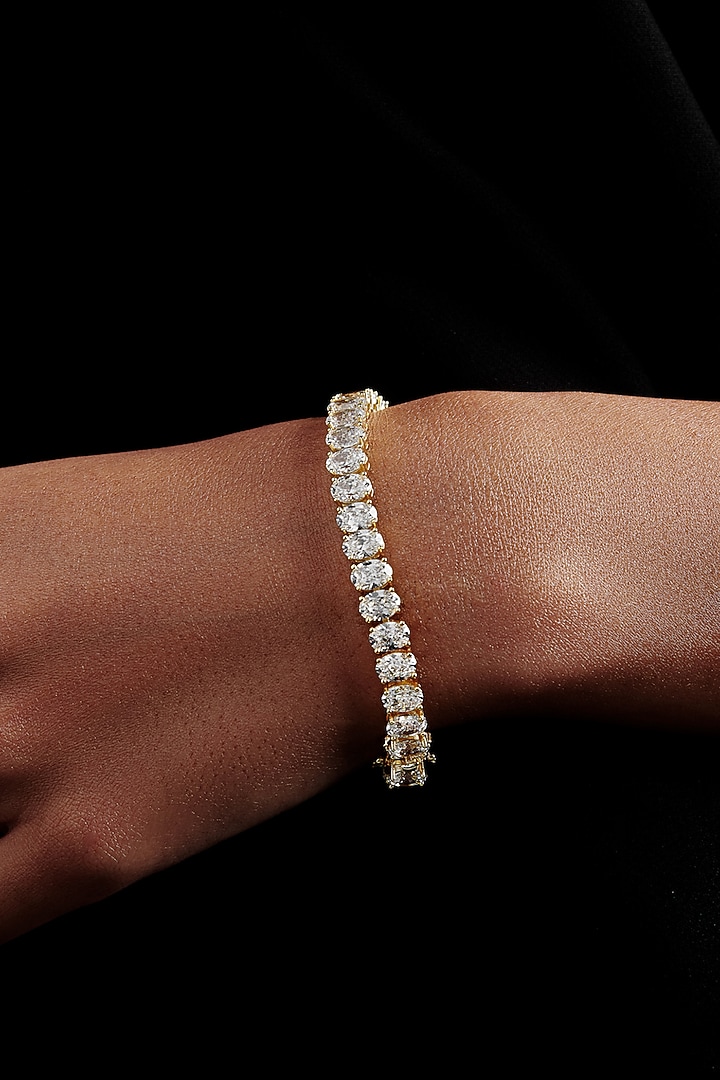 Gold Finish Oval-Shaped Cubic Zirconia Crystal Tennis Bracelet In Sterling Silver by MISS JO at Pernia's Pop Up Shop