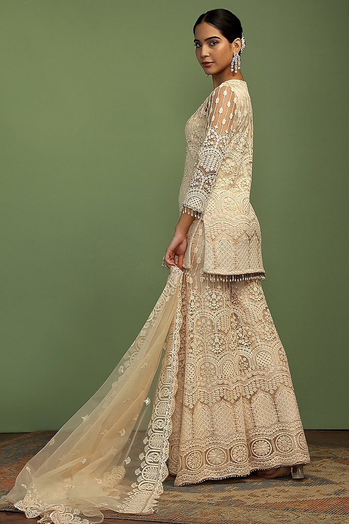 Off-White Net Sequin Embroidered Party Wear Sharara Set by Mustard Moon by Neyha and Vrinda at Pernia's Pop Up Shop