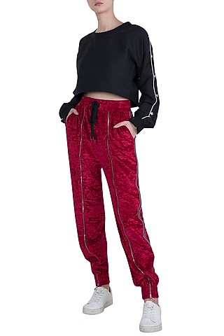 Red velvet track pants by MYRIAD