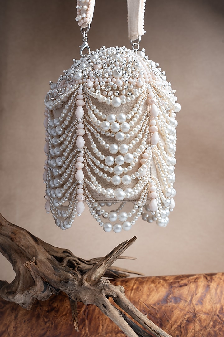 Off-White Suede Pearl Work Potli by Nayaab by Sonia at Pernia's Pop Up Shop