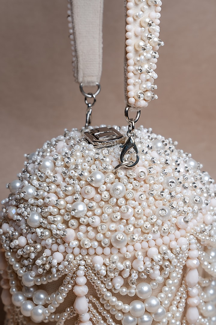Off-White Suede Pearl Work Potli by Nayaab by Sonia at Pernia's Pop Up Shop