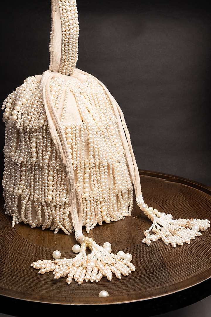 Ivory Suede Pearl Work Potli by Nayaab by Sonia at Pernia's Pop Up Shop